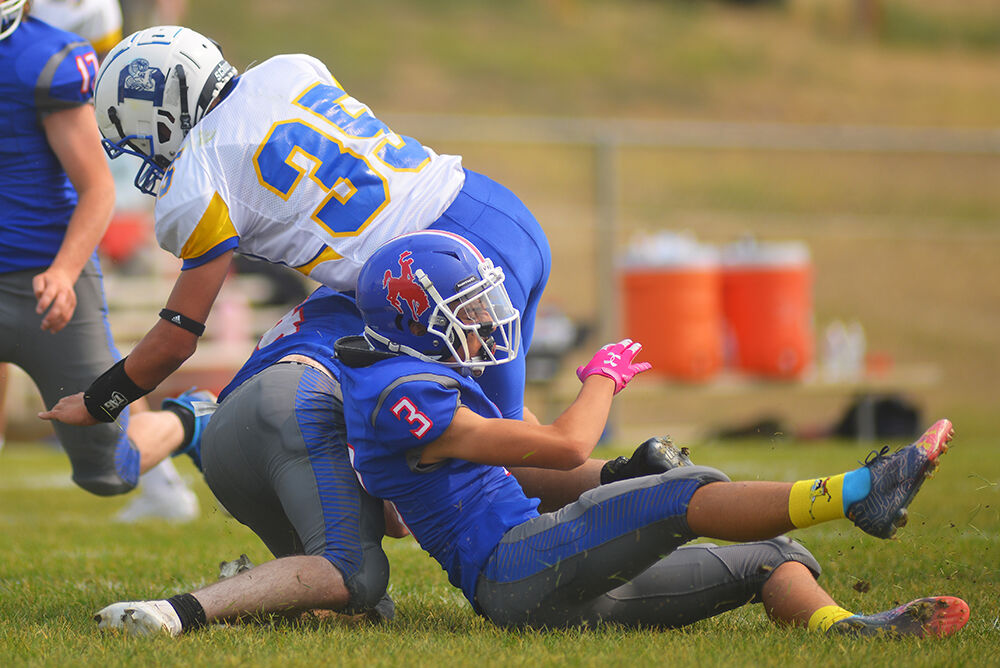 Taylor Cleveland, right, helps senior Sam Ramsbottom tackle Jonah Oard